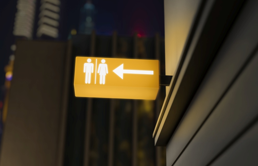 Illuminated sign with male and female symbols and a right-pointing arrow, expertly crafted by a signboard maker in Singapore, indicating the direction to restrooms.