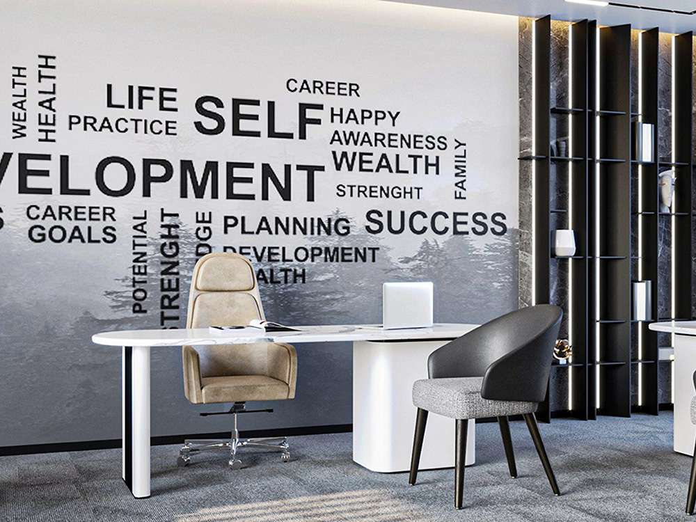 Modern office with a sleek desk, two chairs, and a wall adorned with custom office wall decals displaying motivational words such as "SELF," "DEVELOPMENT," "SUCCESS," and "HEALTH." Bookshelves are visible in the background.