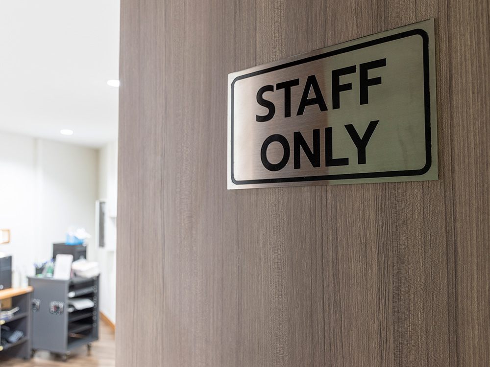 A wooden door with office signage reading "Staff Only" leads to an office area, visible through the doorway.